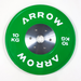 Green weight plate with 'Arrow' branding on a white background