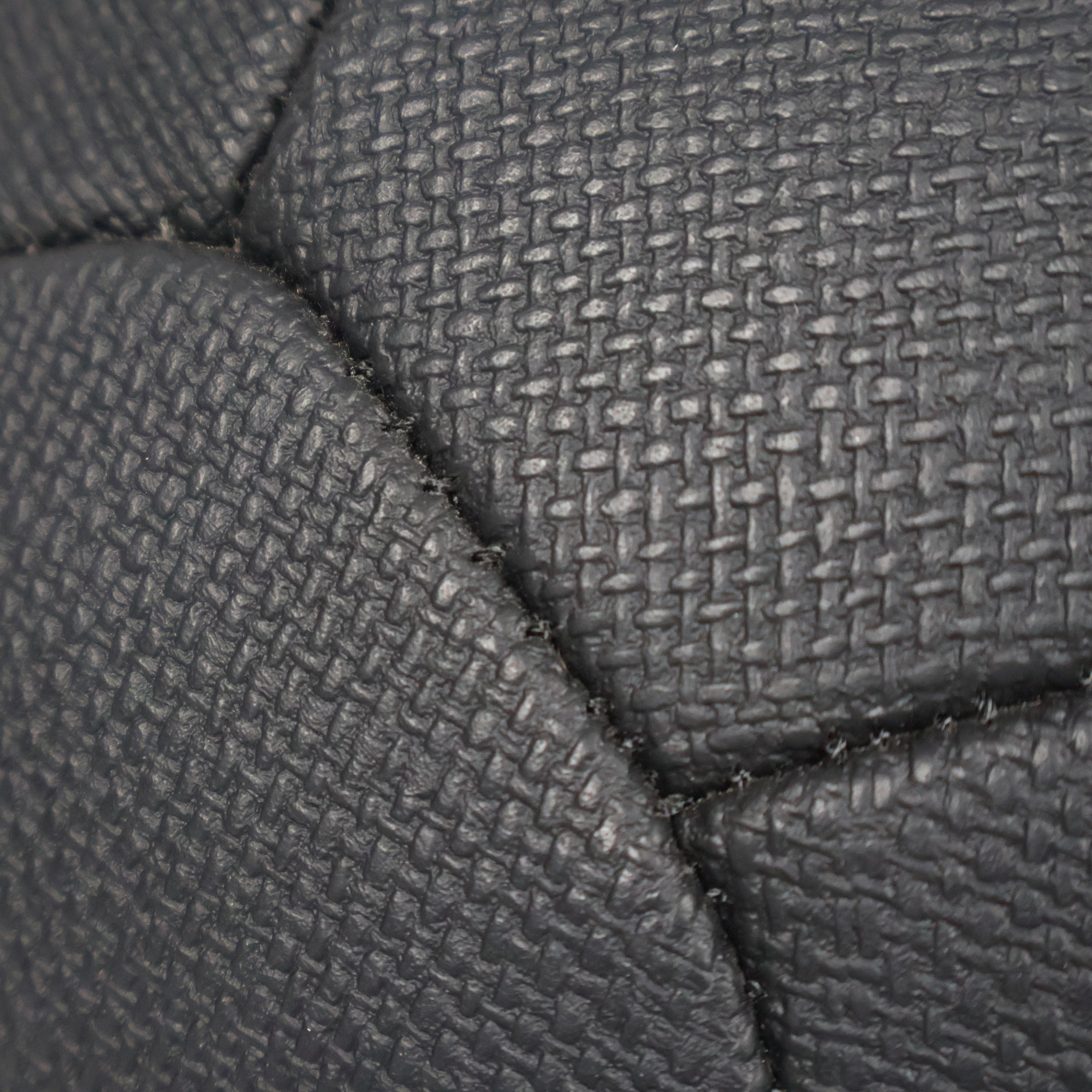 Close-up of black textured fabric with a diamond pattern