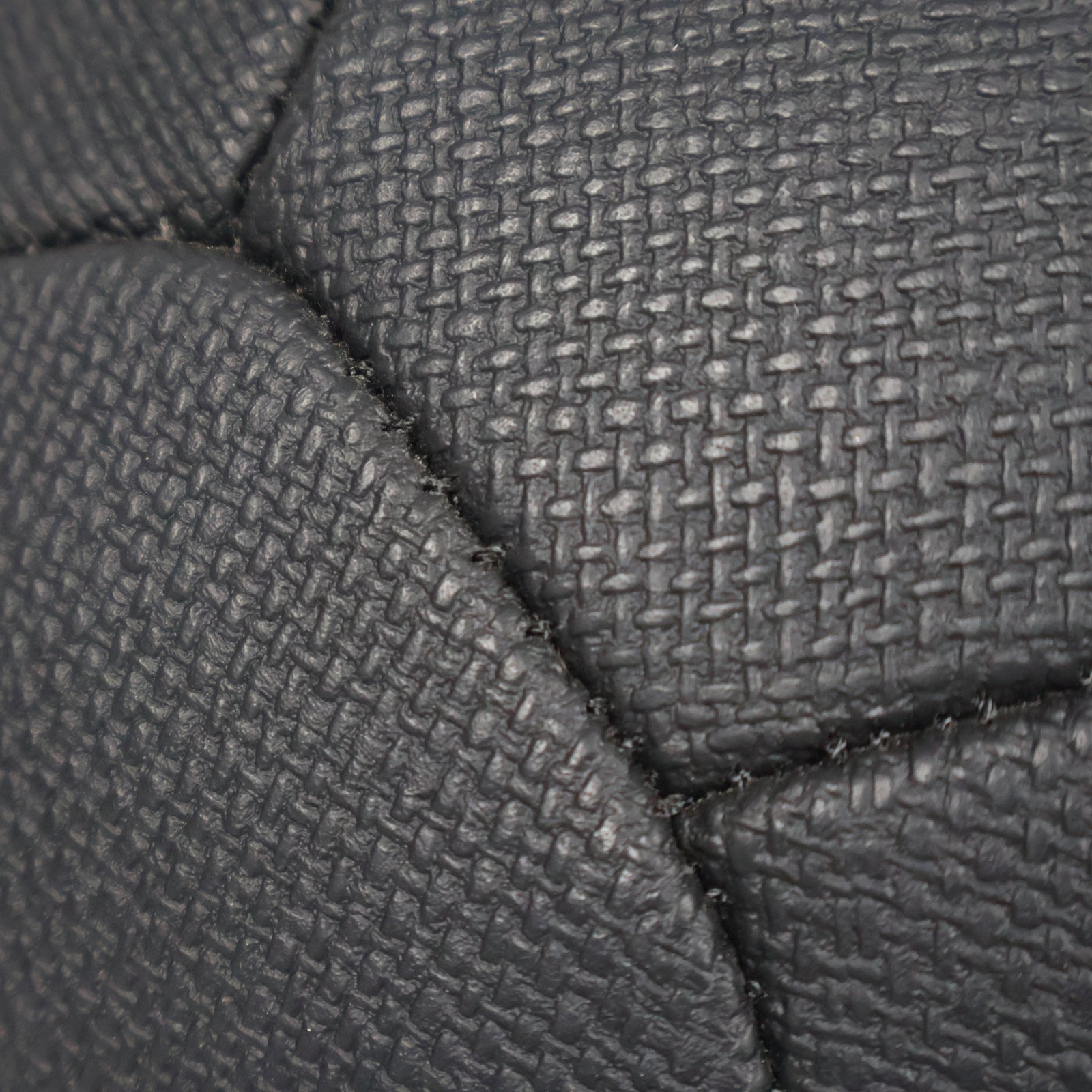 Close-up of black textured fabric with a diamond pattern