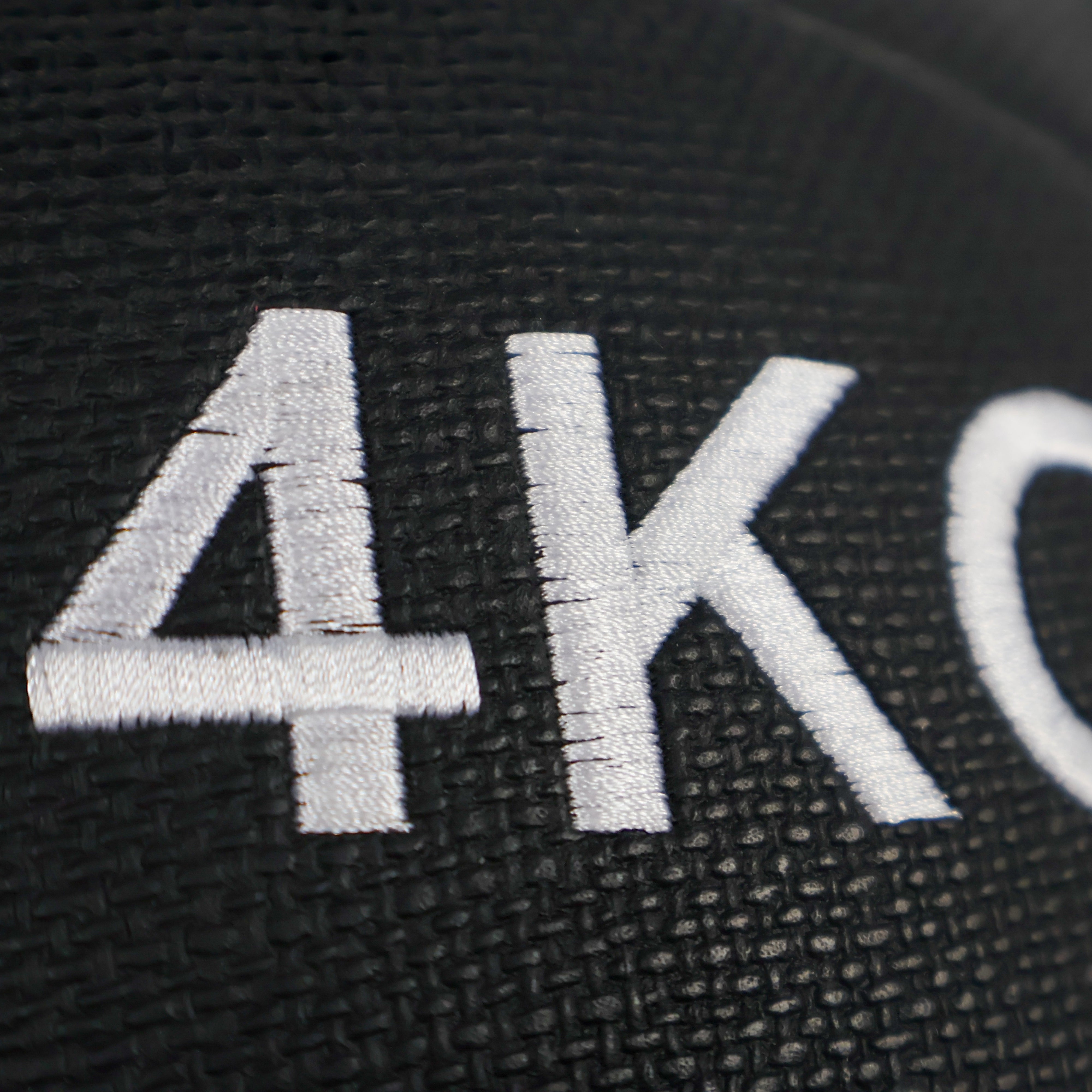 Black wall ball  plate with '4KG' embossed on it