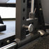 Close-up of a weightlifting bench with metal components on a speckled floor.