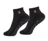 A pair of black low-cut ankle socks with a small gold, white, and black striped detail on the ribbed cuff, and a wavy gray grip pattern on the sole.