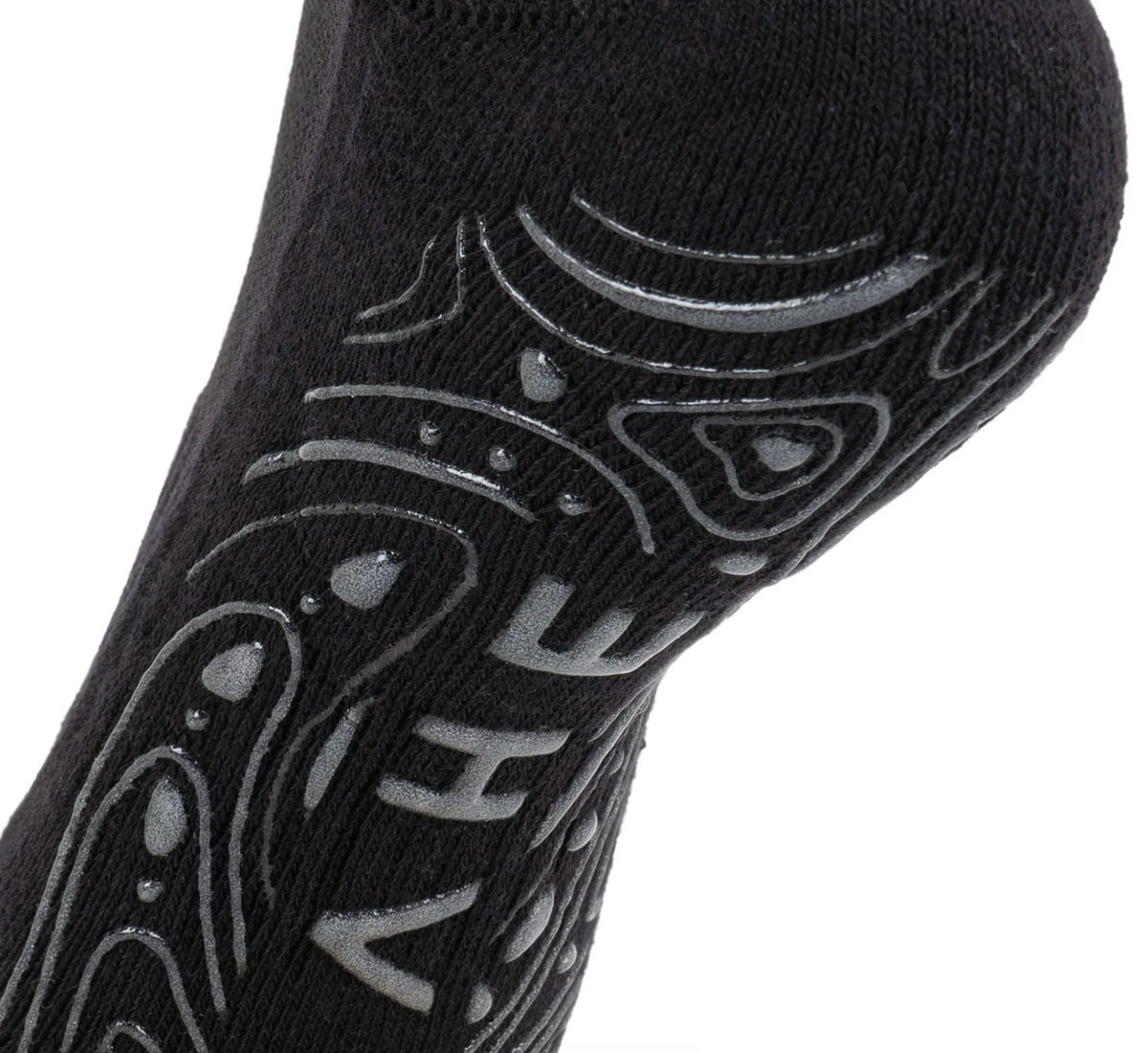 A close-up of a black sock with gray grip patterns and the brand name 'HEY' printed in gray on the side, set against a plain white background.